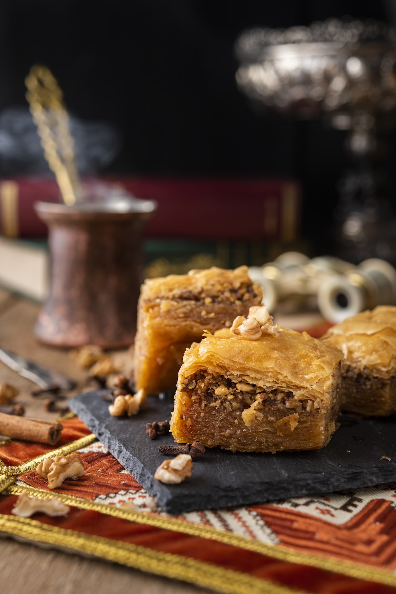 Baklava sweets with nuts on it with coffee and cinnamon